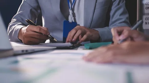 Colleagues working together pointing at business documents during meeting. Stock Footage 344919833