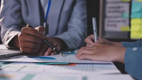 Colleagues working together pointing at business documents during meeting. Stock Footage 344919841