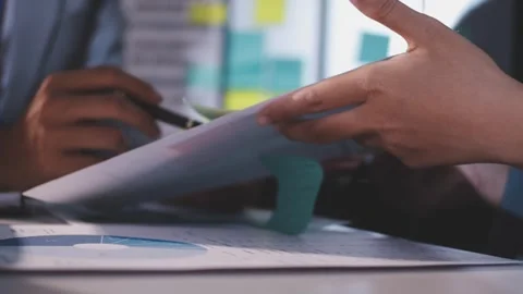 Colleagues working together pointing at business documents during meeting. Stock Footage 344919844