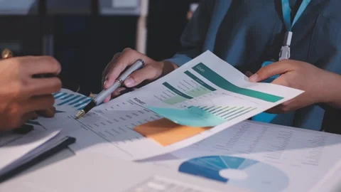 Colleagues working together pointing at business documents during meeting. Stock Footage 344919961