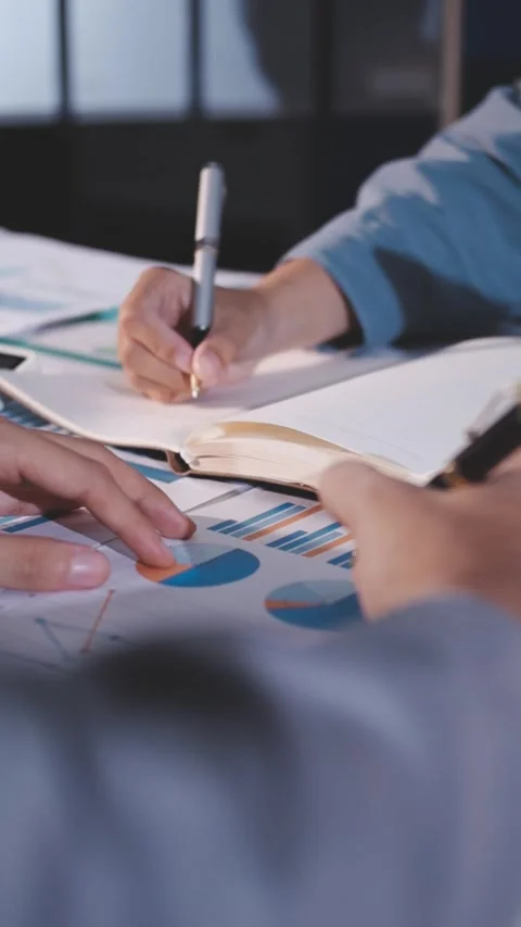 Colleagues working together pointing at business documents during meeting. Stock Footage 344920059