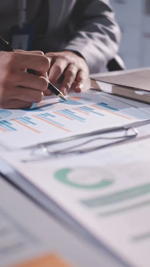 Colleagues working together pointing at business documents during meeting. Stock Footage 344920458