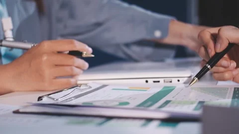 Colleagues working together pointing at business documents during meeting. Stock Footage 344920487