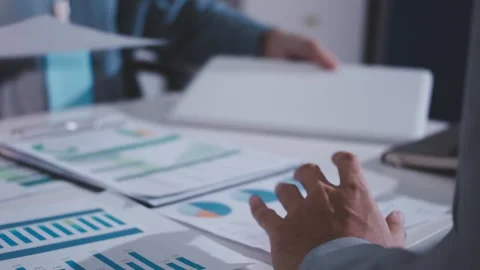 Colleagues working together pointing at business documents during meeting. Stock Footage 344920495