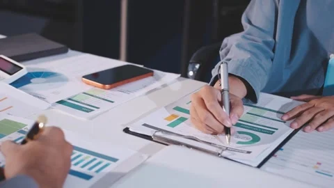 Colleagues working together pointing at business documents during meeting. Stock Footage 344920500