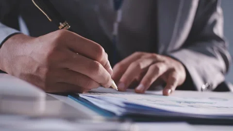 Colleagues working together pointing at business documents during meeting. Video stock 344920985