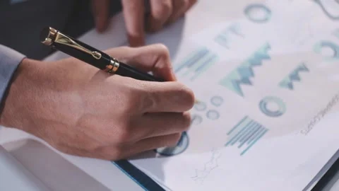 Colleagues working together pointing at business documents during meeting. Stock Footage 344920987