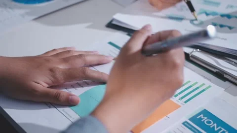 Colleagues working together pointing at business documents during meeting. Stock Footage 344921141