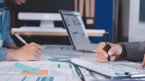 Colleagues working together pointing at business documents during meeting. Stock Footage 344921185