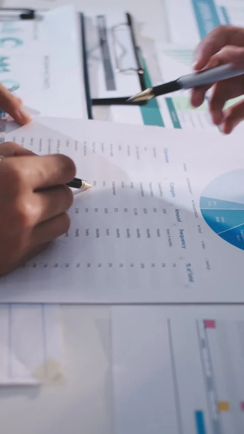 Colleagues working together pointing at business documents during meeting. Stock Footage 344921186