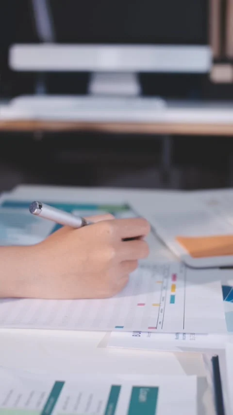 Colleagues working together pointing at business documents during meeting. Stock Footage 344921253