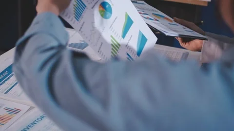 Colleagues working together pointing at business documents during meeting. Stock Footage 344921371