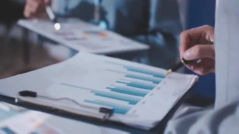 Colleagues working together pointing at business documents during meeting. Stock Footage 344921673