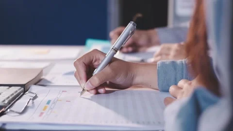 Colleagues working together pointing at business documents during meeting. Stock Footage 344922258