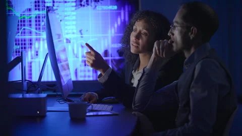 Colleagues Working Together While Analyzing Data in a Modern Office Setting Stock Footage 294274914