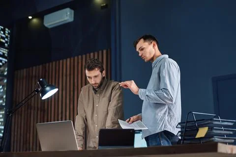 Colleagues working working on a new project after hours. Stock Photos