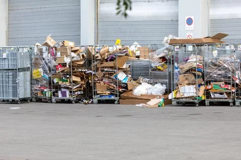 Collected cardboard and plastic packaging waste prepared for recycling behi.. Stock Photos