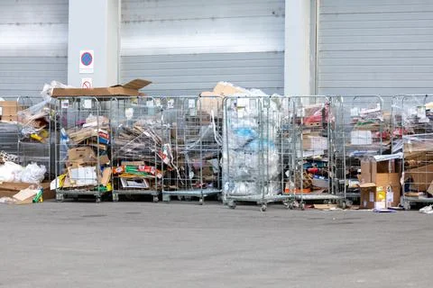 Collected cardboard and plastic packaging waste prepared for recycling behi.. Stock Photos