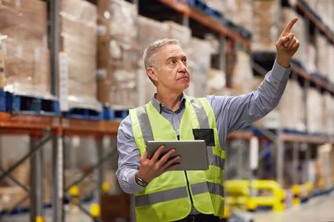 Collecting data on all current stock and merchandise. a mature man using a Fotos de archivo