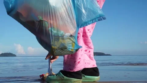 Collecting garbage around the beach Stock Footage 133753278