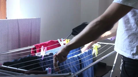 Collecting laundry from the dryer Stock Footage 55532524