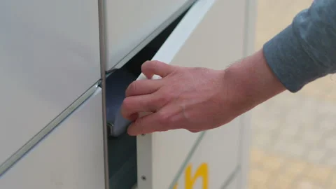 Collecting a parcel from a parcel locker in 4k slow motion 60fps Stock Footage 155729353