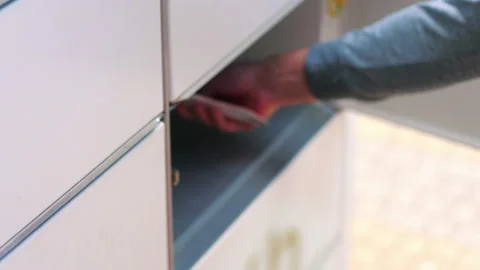 Collecting a parcel from a parcel locker in 4k slow motion 60fps Stock Footage 155729821