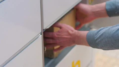 Collecting a parcel from a parcel locker in 4k slow motion 60fps Stock Footage 155729853