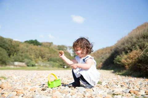 Collecting pebbles Stock Photos