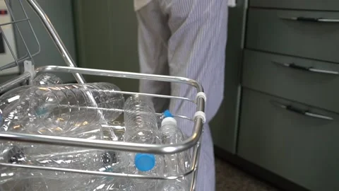 Collecting plastic bottles for recycle in kitchen house Stock Footage 137158732