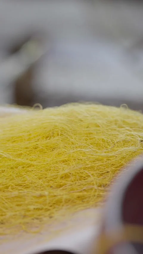 Collecting silk threads into a yellow bundle slow motion reeling process Stock Footage 322185950