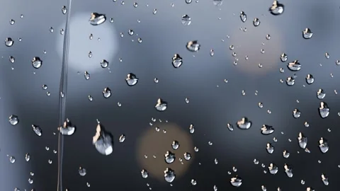Collecting water droplets at window forming streaks and sliding from light rain Stock Footage 341865102