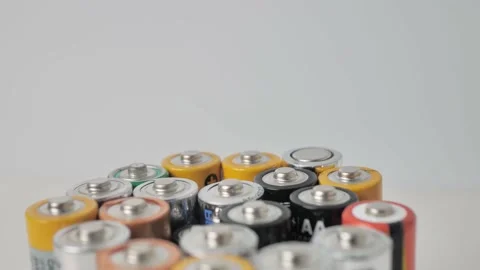 The collection of AA batteries, extremely close-up, is rotating. The batteries Stock Footage 161338219