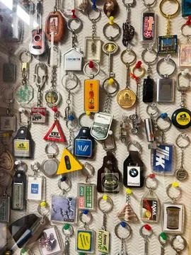 Collection of assorted keychains with colorful designs displayed on a textu.. Stock Photos