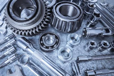Collection of assorted mechanical tools and equipment arranged on a metallic Stock Photos