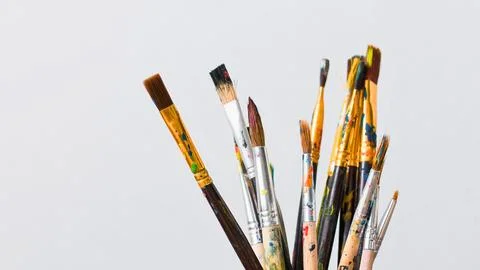 A collection of assorted paint brushes on a white background Stock Photos
