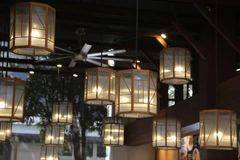 A collection of beautiful lanterns hangs from the ceiling in an outdoor res.. Stock Photos