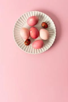A collection of beautifully dyed Easter eggs in various shades rests on a d.. Stock Photos