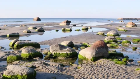 Collection of big boulder rocks surfaced on the sea bed during a low tide Stock-Footage 162272221