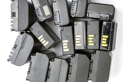 Collection of black digital camera rechargeable lithium-ion batteries piled Stock Photos