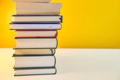 Collection of Book stack in the library room on yellow background Fotos Stock