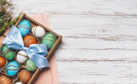 Collection bright eggs box pink craft paper near plants Stock Photos