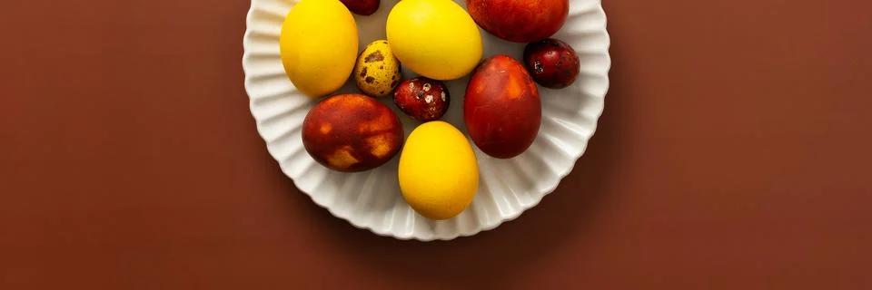 A collection of brightly colored Easter eggs in various sizes and patterns is Stock Photos