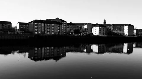 A collection of buildings reflecting on the surface of the river Stock Footage 171799935