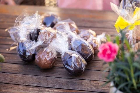 A collection of chocolate easter eggs wrapped in clear plastic placed on a .. Stock Photos