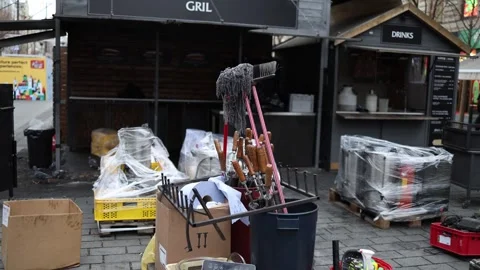 A collection of cleaning tools, utensils, and supplies placed outside food stall Stock Footage 297265656