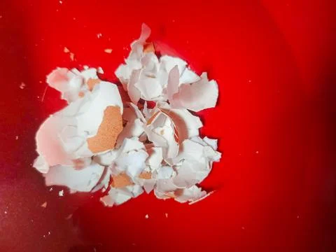 A collection of crushed egg shells on a red background Stock Photos