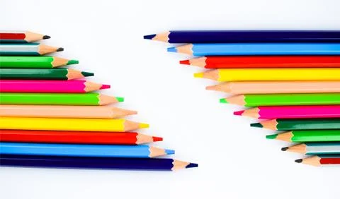 Collection of different colored pencil crayons arranged in two rows making a Foto stock
