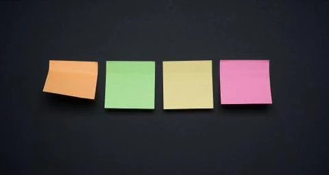 Collection of different colored sticker note papers on black background Stock Photos