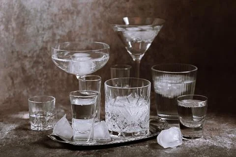 Collection of different glasses filled with cold water with ice Stock Photos